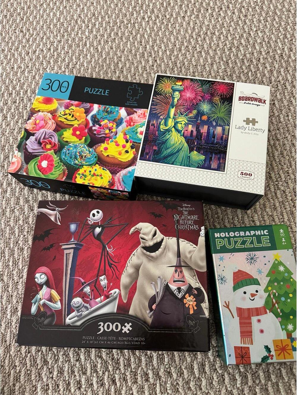 Set of four puzzles featuring vibrant themes including cupcakes, Lady Liberty, a